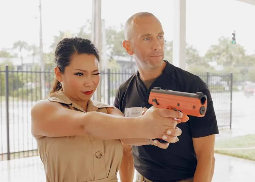 A first-time shooter being coached through a Byrna launcher